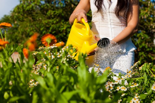Gardeners wearing PPE while mowing and pruning